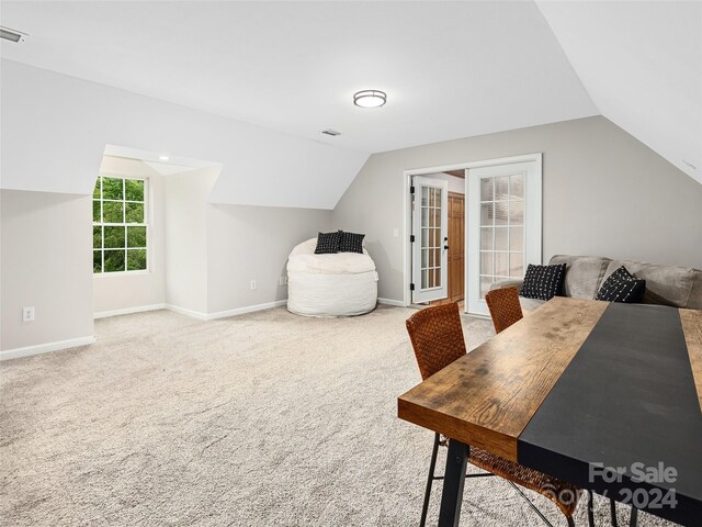 home office featuring carpet floors and vaulted ceiling