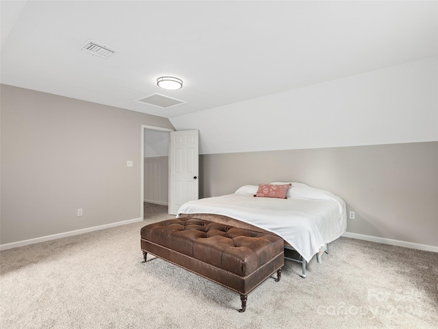 bedroom featuring vaulted ceiling and light colored carpet