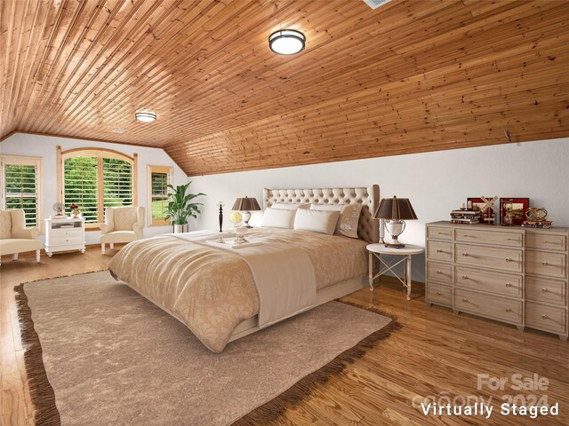 bedroom with light wood-type flooring, vaulted ceiling, and wooden ceiling