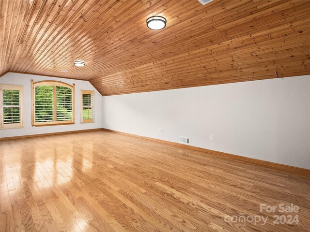 bonus room featuring light wood-type flooring, lofted ceiling, and wooden ceiling