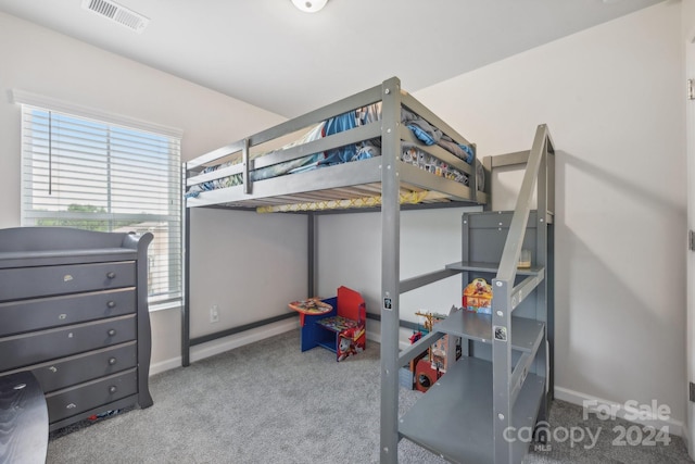 bedroom featuring light carpet