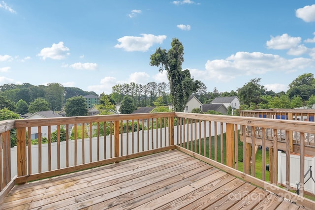 wooden deck featuring a lawn