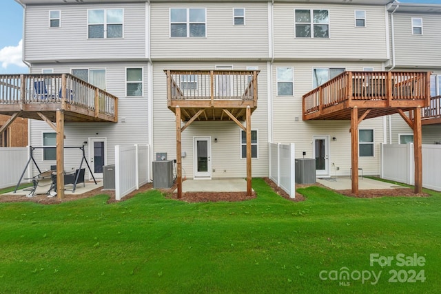 rear view of house with fence, a patio area, a yard, and central AC unit