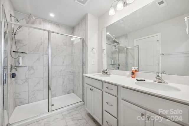 bathroom with a shower stall, visible vents, marble finish floor, and a sink
