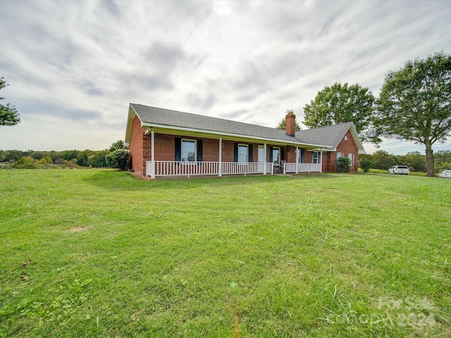 8510 Olive Branch Rd, Marshville, NC 28103 - ranch-style home with a chimney, covered porch, a front yard, and brick siding