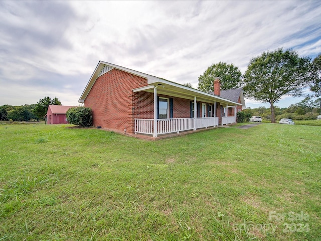 8510 Olive Branch Rd, Marshville, NC 28103 - view of property exterior with brick siding, a chimney, a yard, and covered porch