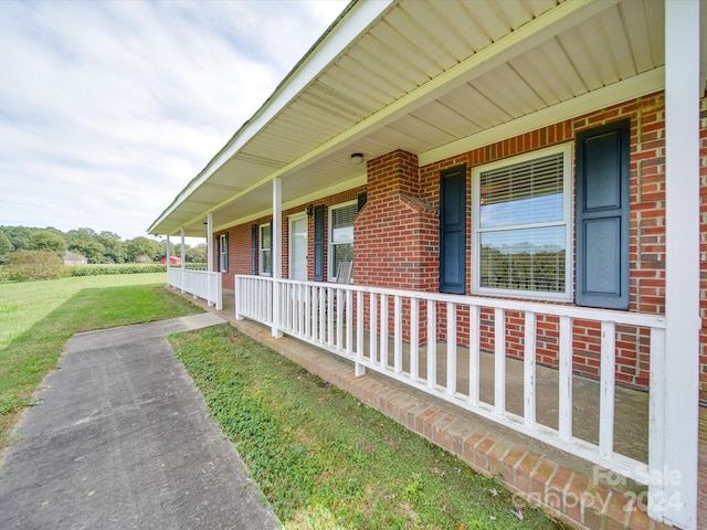 8510 Olive Branch Rd, Marshville, NC 28103 - view of home's exterior with a porch, brick siding, and a yard