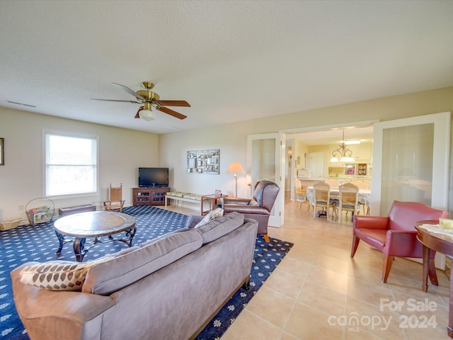 8510 Olive Branch Rd, Marshville, NC 28103 - living room with light tile patterned floors, a ceiling fan, and a textured ceiling