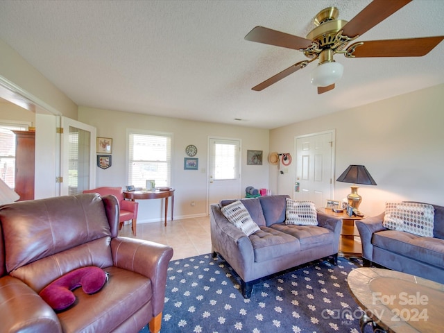 8510 Olive Branch Rd, Marshville, NC 28103 - living area with a ceiling fan, tile patterned flooring, baseboards, and a textured ceiling