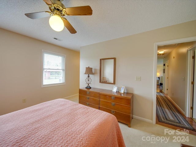 8510 Olive Branch Rd, Marshville, NC 28103 - bedroom with a textured ceiling, light carpet, a ceiling fan, and baseboards