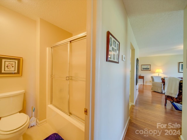 8510 Olive Branch Rd, Marshville, NC 28103 - corridor with a textured ceiling, wood finished floors, and baseboards
