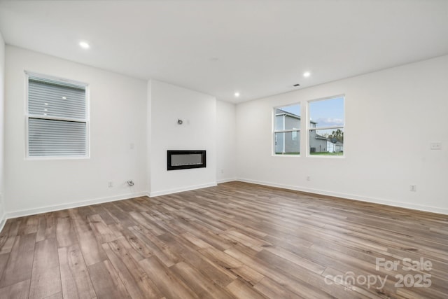 unfurnished living room with light wood-type flooring