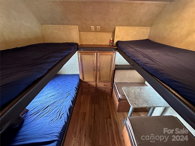 bedroom with dark wood-type flooring