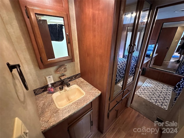 bathroom featuring hardwood / wood-style flooring and vanity