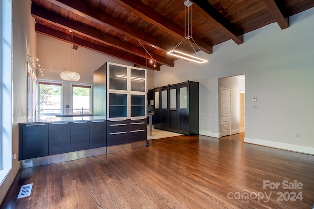 interior space featuring wood ceiling, lofted ceiling with beams, and hardwood / wood-style floors