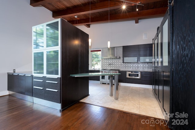 kitchen featuring wooden ceiling, beam ceiling, wall chimney exhaust hood, modern cabinets, and backsplash