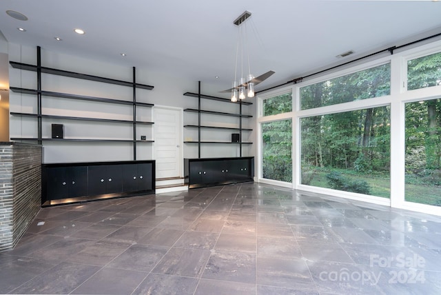 unfurnished living room with recessed lighting
