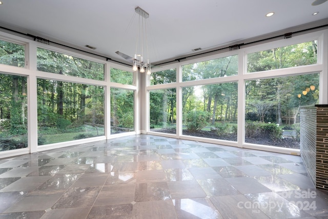 unfurnished sunroom with a wealth of natural light