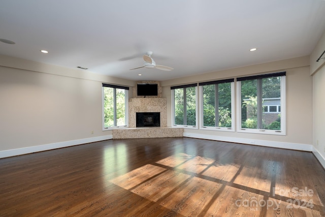 unfurnished living room featuring ceiling fan and dark hardwood / wood-style flooring