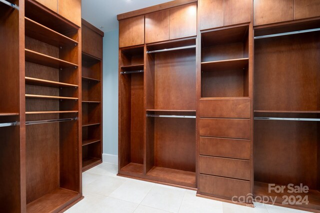 spacious closet with light tile patterned floors