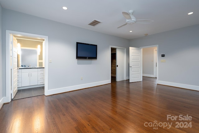 unfurnished bedroom featuring sink, ceiling fan, ensuite bathroom, and dark hardwood / wood-style flooring