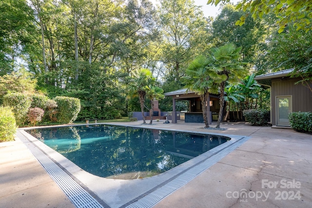 outdoor pool with a patio area