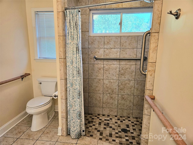 bathroom with toilet, a shower with shower curtain, and tile patterned floors