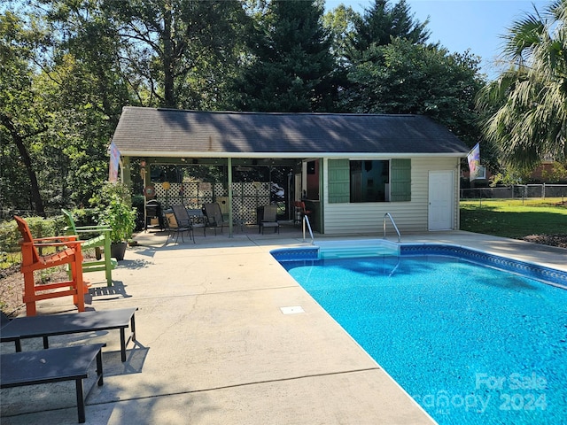 view of swimming pool featuring a patio area