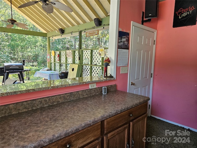 exterior space featuring vaulted ceiling, ceiling fan, and vanity