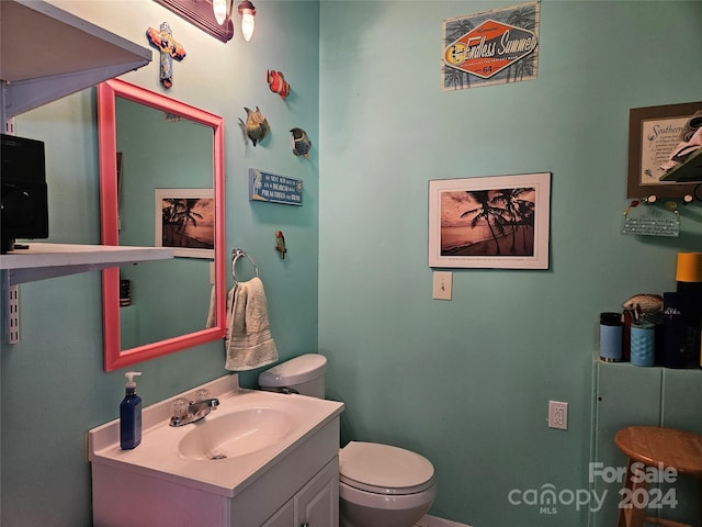 bathroom featuring vanity and toilet