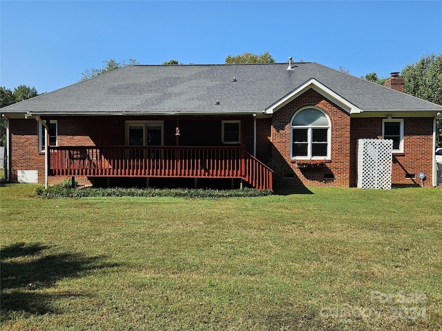 back of house featuring a wooden deck and a yard