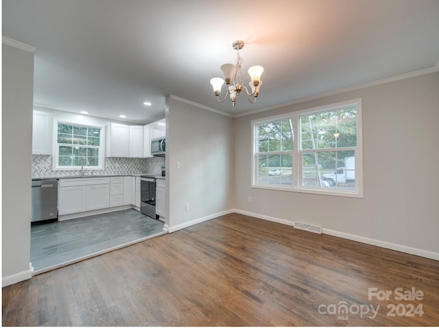 kitchen featuring white cabinets, hanging light fixtures, stainless steel appliances, and dark hardwood / wood-style floors