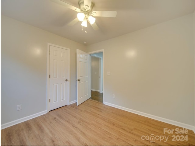 unfurnished bedroom with ceiling fan and light hardwood / wood-style floors