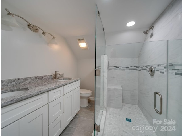 bathroom featuring toilet, vaulted ceiling, an enclosed shower, and vanity