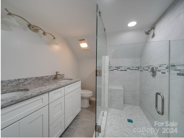 bathroom featuring vanity, toilet, tile patterned floors, vaulted ceiling, and a shower with door