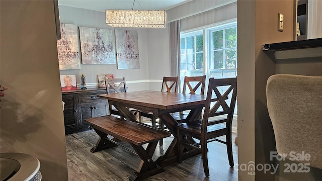 dining space featuring hardwood / wood-style floors and a chandelier