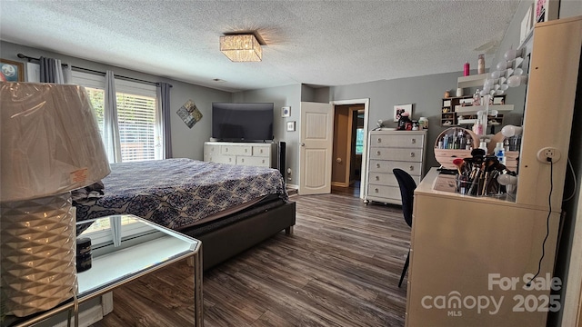 bedroom with dark hardwood / wood-style flooring and a textured ceiling