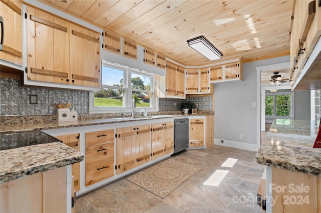 kitchen with light brown cabinetry, light stone countertops, and backsplash