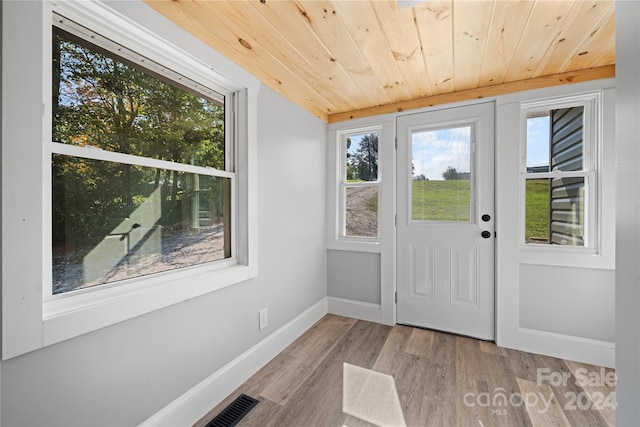 doorway to outside with light hardwood / wood-style floors and wooden ceiling