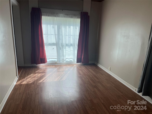 spare room featuring dark hardwood / wood-style flooring