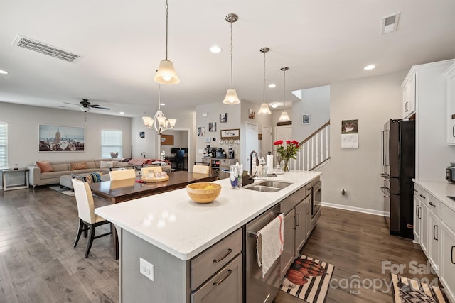 kitchen with white cabinets, hanging light fixtures, sink, stainless steel dishwasher, and high end refrigerator