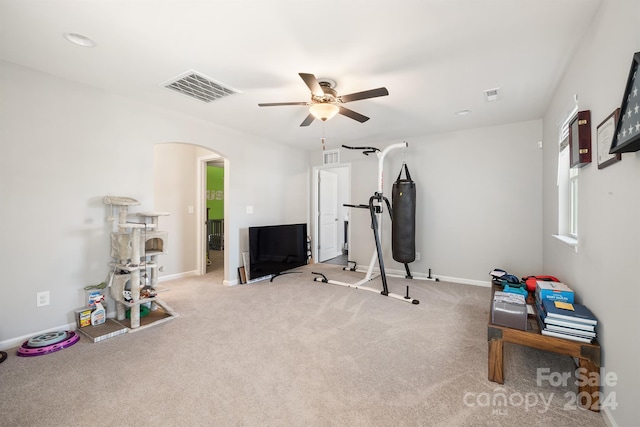 exercise area with light carpet and ceiling fan