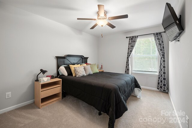 bedroom with light carpet and ceiling fan