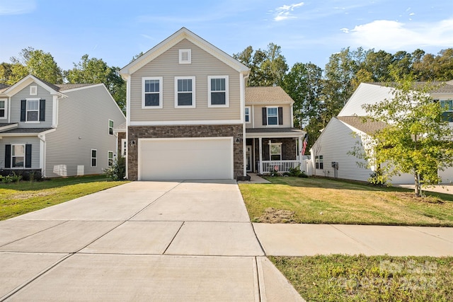 view of front of house featuring a porch, a garage, and a front yard