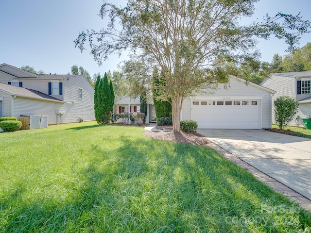 view of front of property with a front lawn and a garage