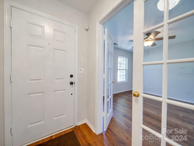 entrance foyer with ceiling fan, french doors, and dark wood-type flooring