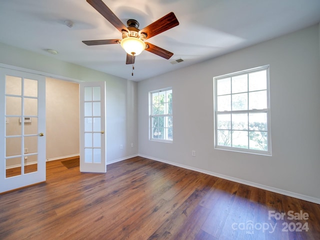 unfurnished room featuring french doors, dark hardwood / wood-style flooring, and ceiling fan