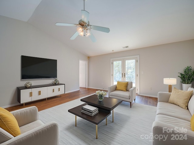 living room with ceiling fan, light hardwood / wood-style flooring, french doors, and vaulted ceiling