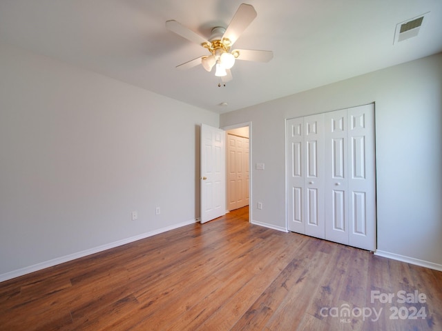 unfurnished bedroom featuring ceiling fan and hardwood / wood-style floors