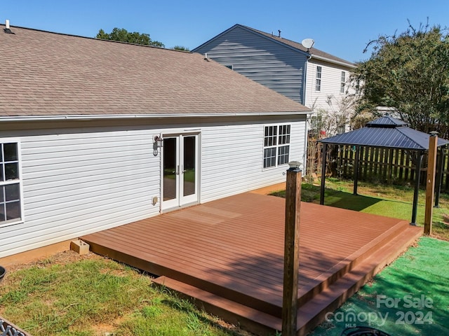 wooden terrace featuring a gazebo and a yard